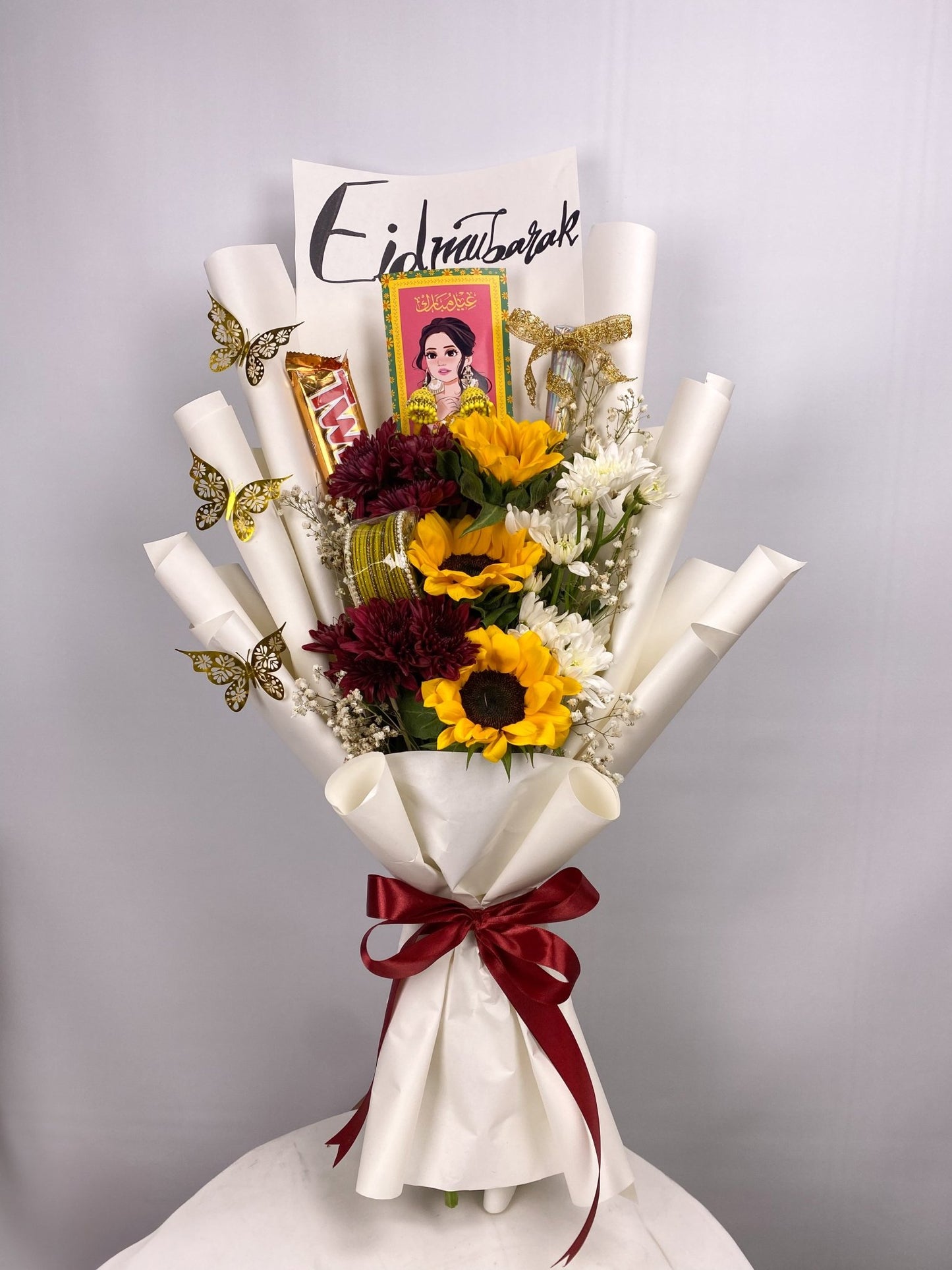 Bouquet with flowers, ribbons, and a card on a white background. Send flowers to islamabad. send flowers to pakistan