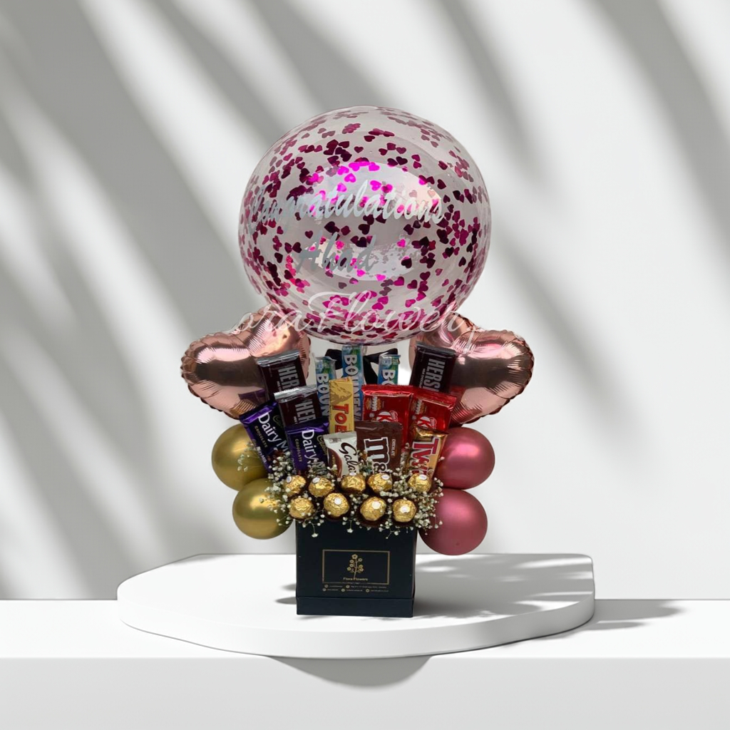 Fresh floral arrangement of orchids and tulips in a modern office setting.. Send flowers to lahore. send flowers to Pakistan