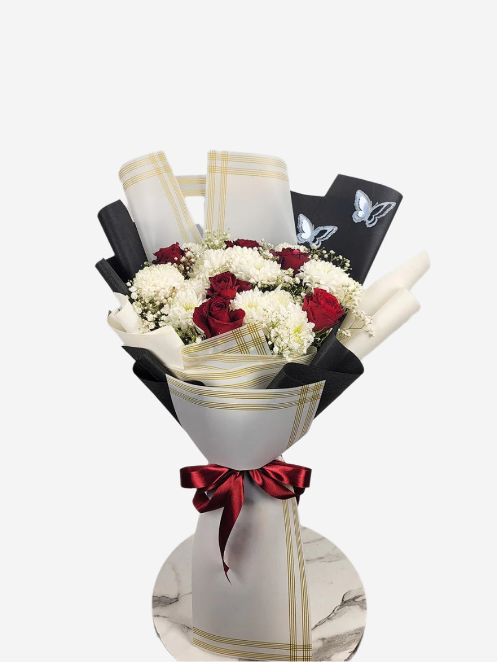 A bouquet of flowers including red and white roses, chrysanthemums, baby's breath, and butterflies, wrapped with a black and white theme. Send flowers to islamabad. send flowers to pakistan