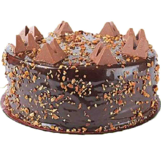 Chocolate cake with chocolate shavings and decorative elements on a white background
