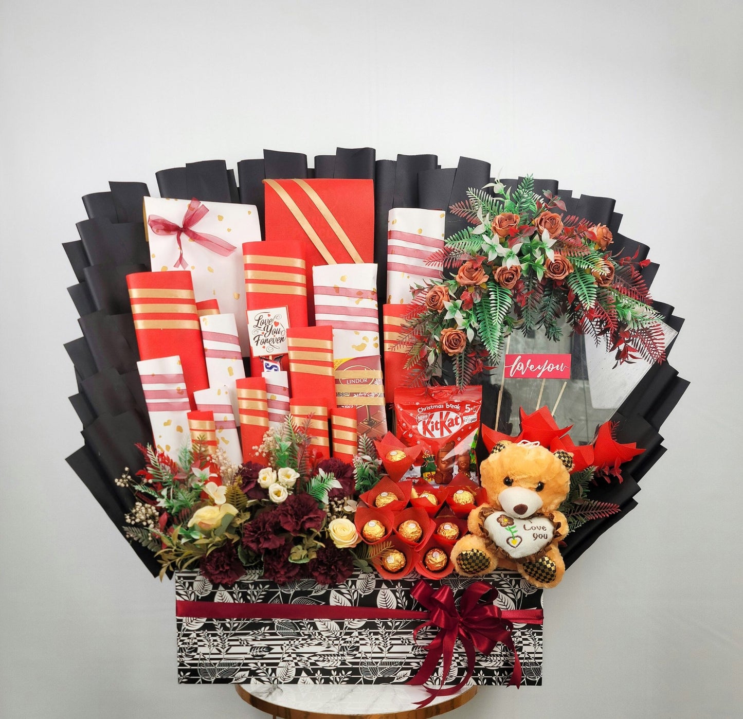 Greeting card display with floral arrangements, gift boxes, and a teddy bear on a white background