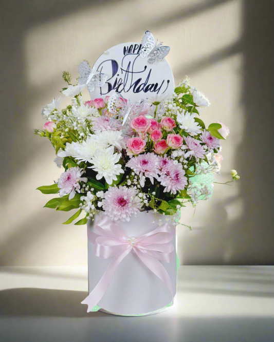 Bouquet of flowers with a 'Happy Birthday' card on a white background