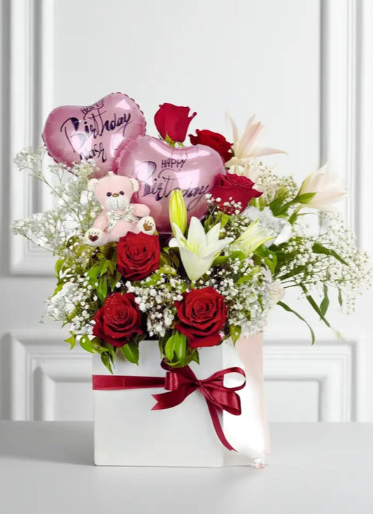 Bouquet of flowers with heart-shaped balloons and teddy bears on a white background