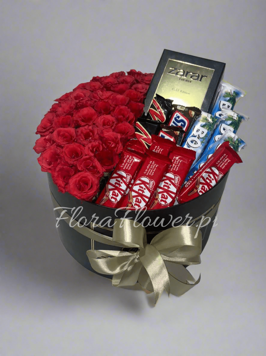 A round arrangement of red roses with chocolate bars and a bottle of perfume, tied with a gold ribbon. Send flowers to islamabad. send flowers to pakistan
