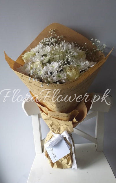 A bouquet of flowers consisting of roses, chrysanthemums, and baby's breath, wrapped in premium wrapping paper.