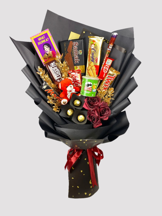 A bouquet arrangement featuring an assortment of chocolate bars and candies, with decorative elements such as Twix, Kitkat, Mars, and Hershey's, presented with artificial flowers and adorned with red ribbon.