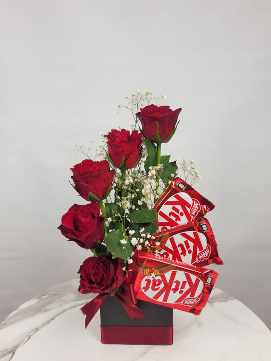 Bouquet of red roses with KitKat chocolate bars on a white background
